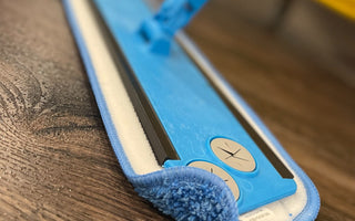 Microfiber flat mop with frame and handle on wood floor