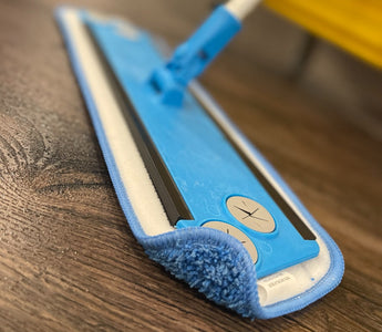 Microfiber flat mop with frame and handle on wood floor